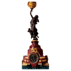 A Signed Bronze Statue of a Nymph set on a Rouge marble gilt bronze clock base