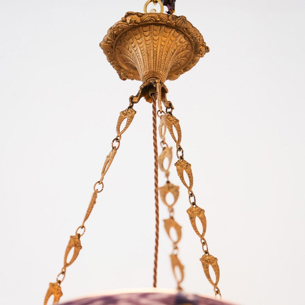 A Signed Jean Noverdy Glass Plafonnier, c1925

Suspended on ormolu metal mounts the marmoreal mottled glass shade glass shade bears an etched signature NOVERDY

The Nouvelle Verrerie De Dijon  manufactured light shades and vases in the style of
