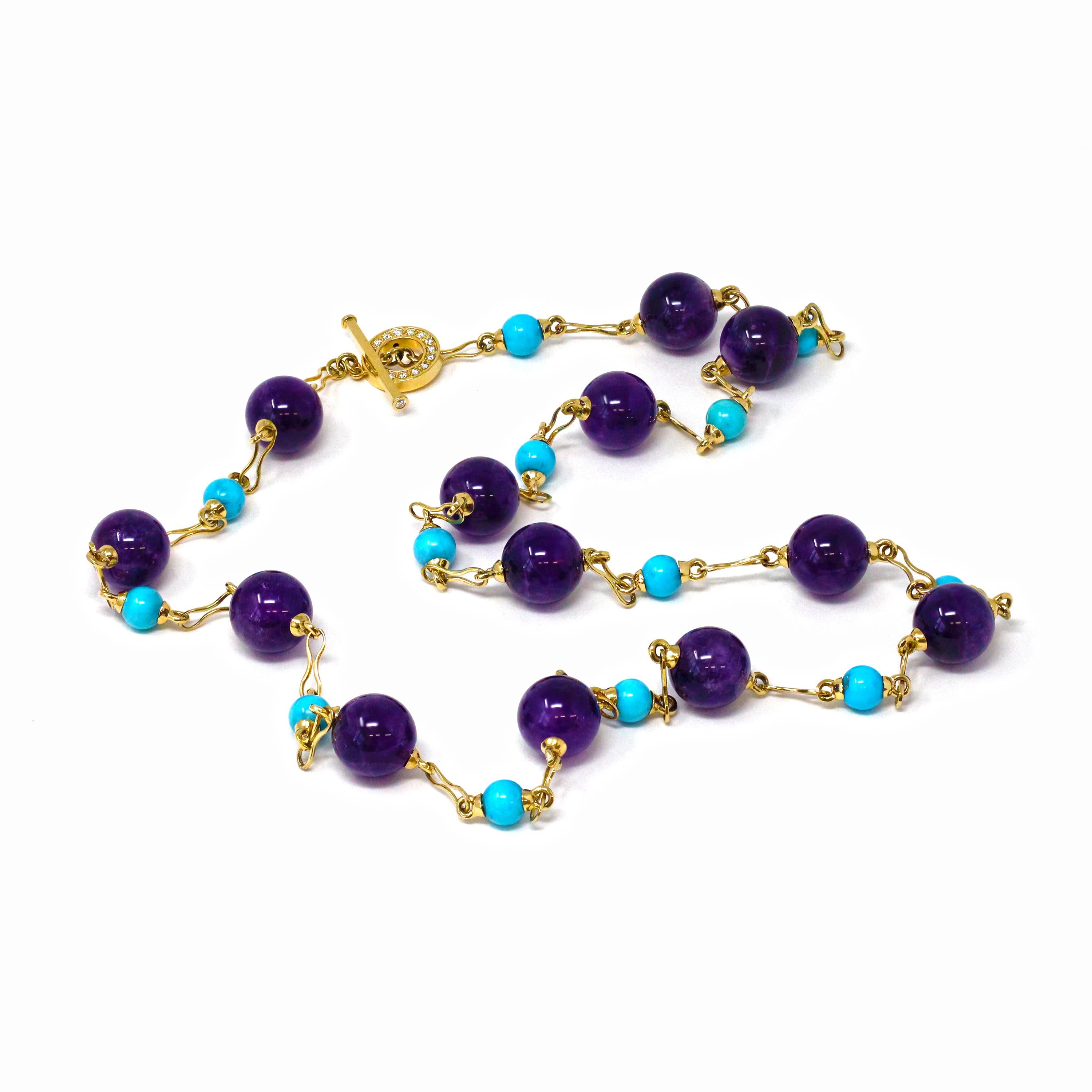 A signed Rosaria Varra long station necklace featuring alternated natural turquoise round beads measuring 8-9mm and amethyst round beads measuring 16mm, set in 18k yellow gold with a 0.54 carat of GH color and VS-SI clarity diamond clasp made into a