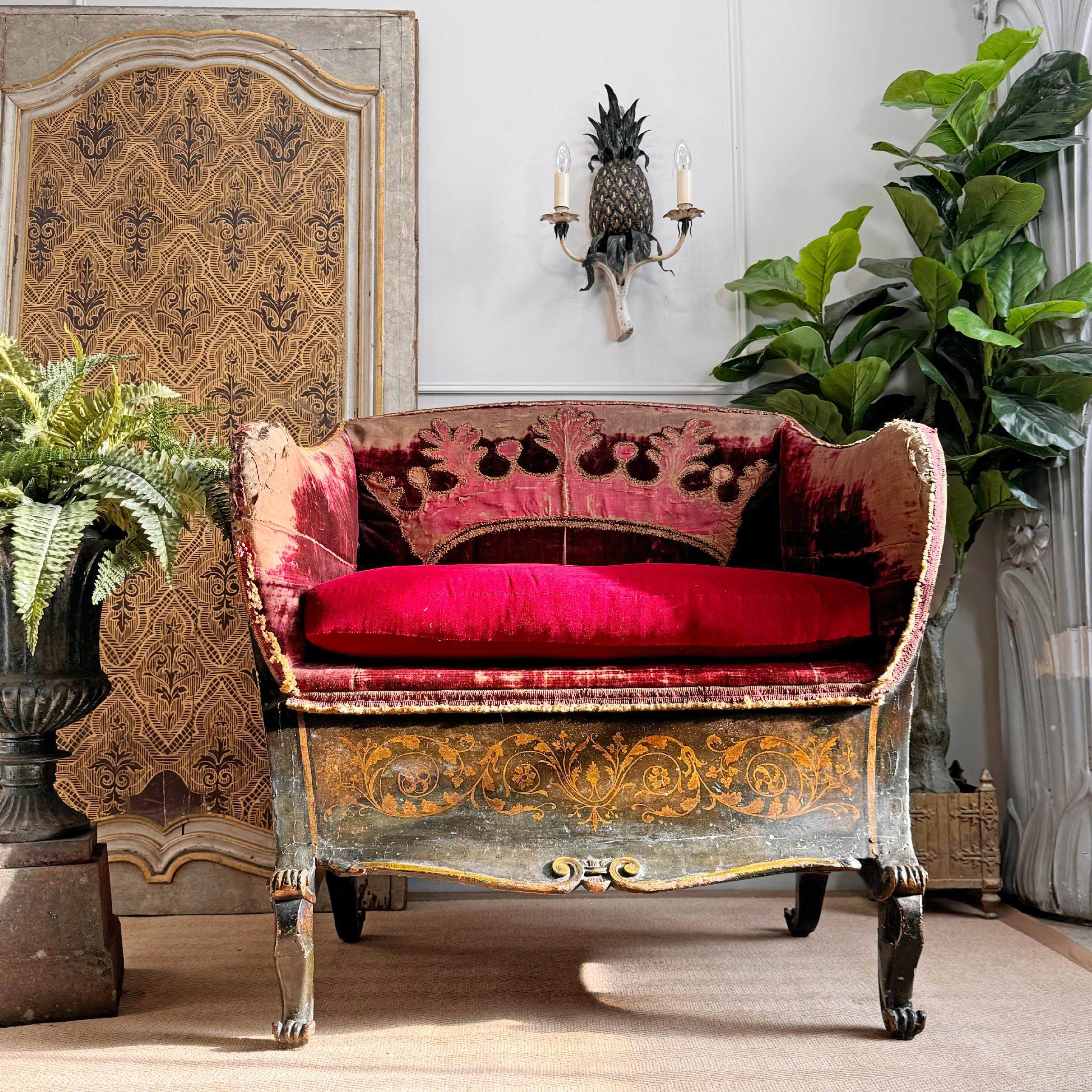 This outstanding piece of French Nobility history with its opulent hand painted lacquered decoration featuring classical figures and motifs, set upon a deep, dark olive green background in gilt. 

The sweeping sleigh back form and wide, open seat,