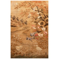 A silk tapestry depicting a landscape with birds in flight