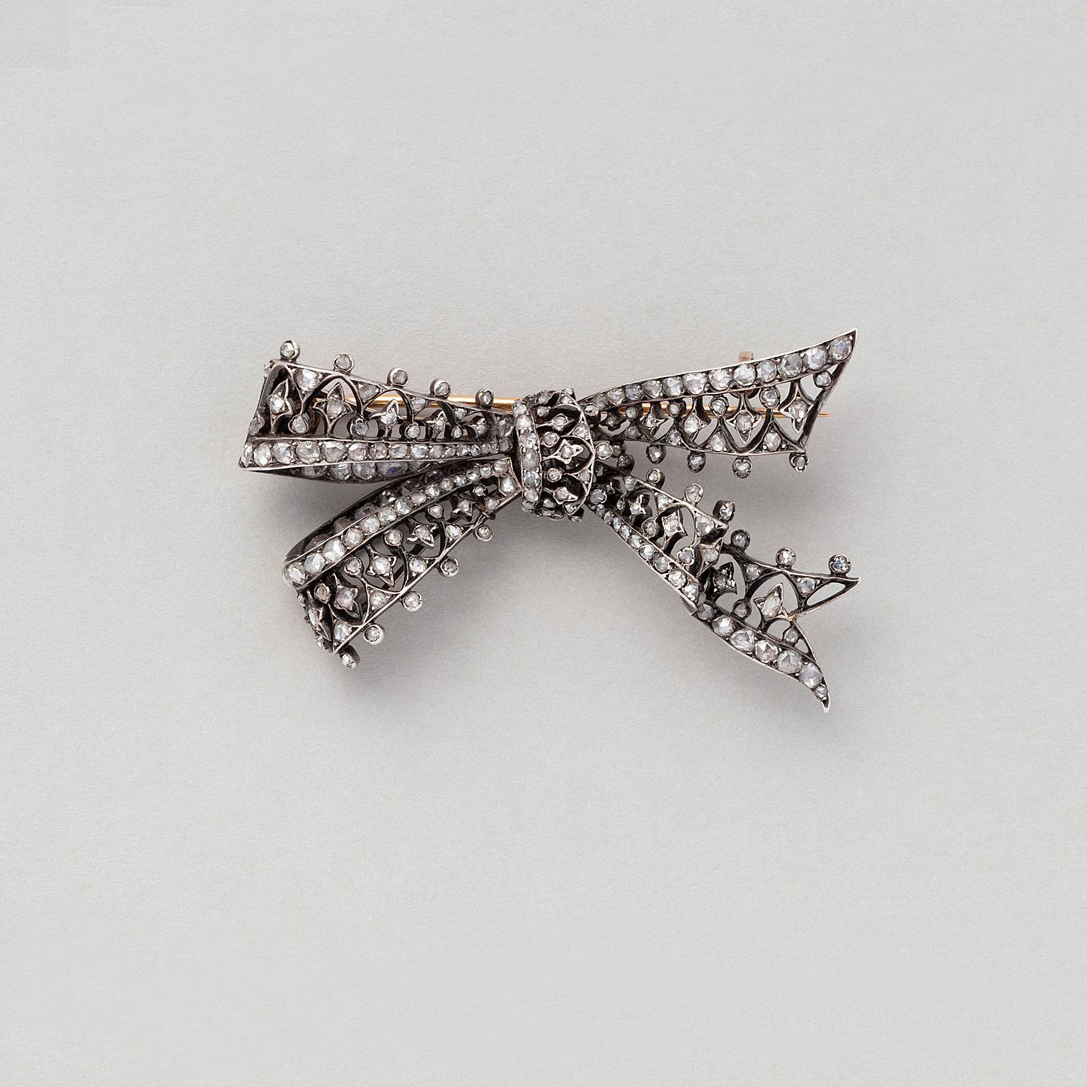 An 18 carat gold bow brooch open worked and set with rose cut diamonds, numbered, 657, with French assay marks, France, circa 1880.

weight: 16.15 grams
dimensions: 6 x 4 cm