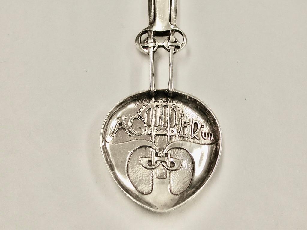 A Silver Archibald Knox coronation caddy spoon made for Liberty & Co, 1901. The handle with integral celtic knot design. The spoon is inscribed AC ER VII for “Anno Coronation, Edward Rex VII”.
This spoon is heavy quality and hand crafted in an arts