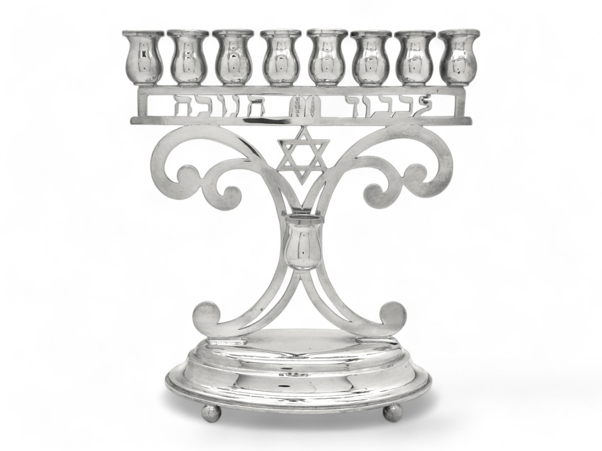 Modern and stylish Hanukkah lamp made at the beginning of the modern period of the 20th century in Austria.

Hannukah lamp is mounted on a well-rounded oval stepped base which is supported by four ball feet.

Main body is pierced with four large