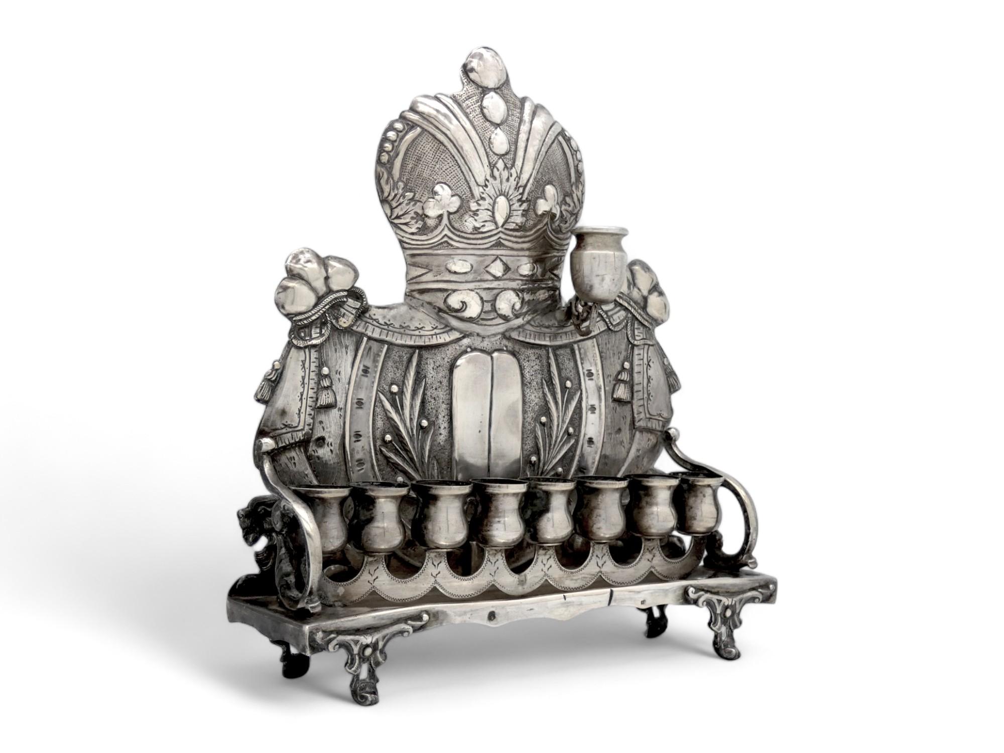An elegant Austrian Hanukkah lamp made in the late 19th century.

The Backplate of this Hanukkah lamp is designed similar to many Torah shields made in that province and that part of the 19th century.

A gorgeous Torah crown with flaring leaf,