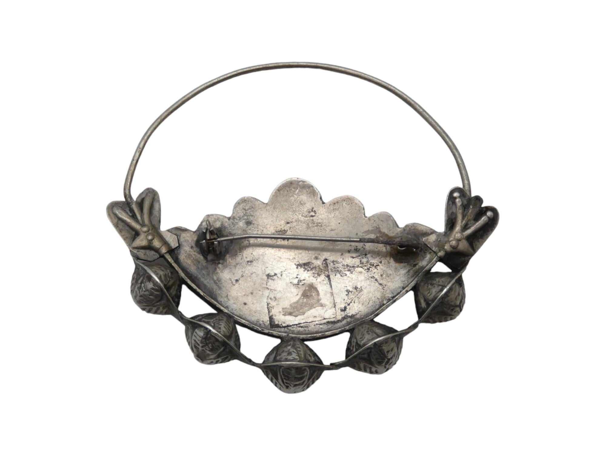 This distinctive silver brooch, crafted in the Caucasus region (Kavkaz) circa 1900, is a remarkable example of the region’s rich decorative traditions. The brooch features a large, prominent ring at the top, gracefully flowing into the sides and