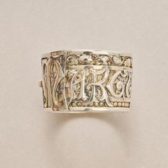 A Silver Couquaux wide bangle with the name Marguerite