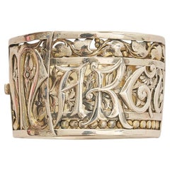 A Silver Couquaux wide bangle with the name Marguerite