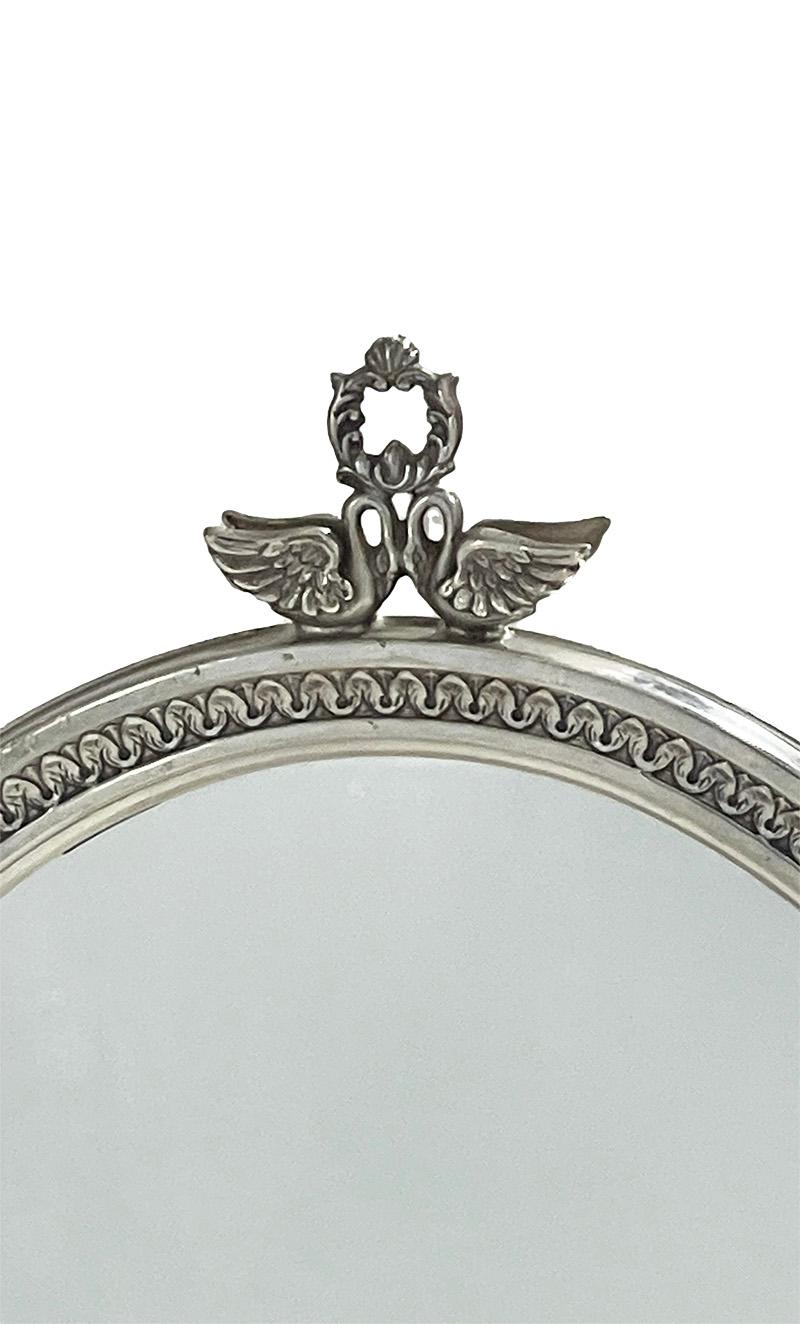 A silver dressing table mirror by Pedro Durán Morales, Madrid

An oval silver mirror, raised on a round base with swan carries the oval ring for the rotating mirror. The mirror surrounded in leave pattern and on top two small romantic swan towards