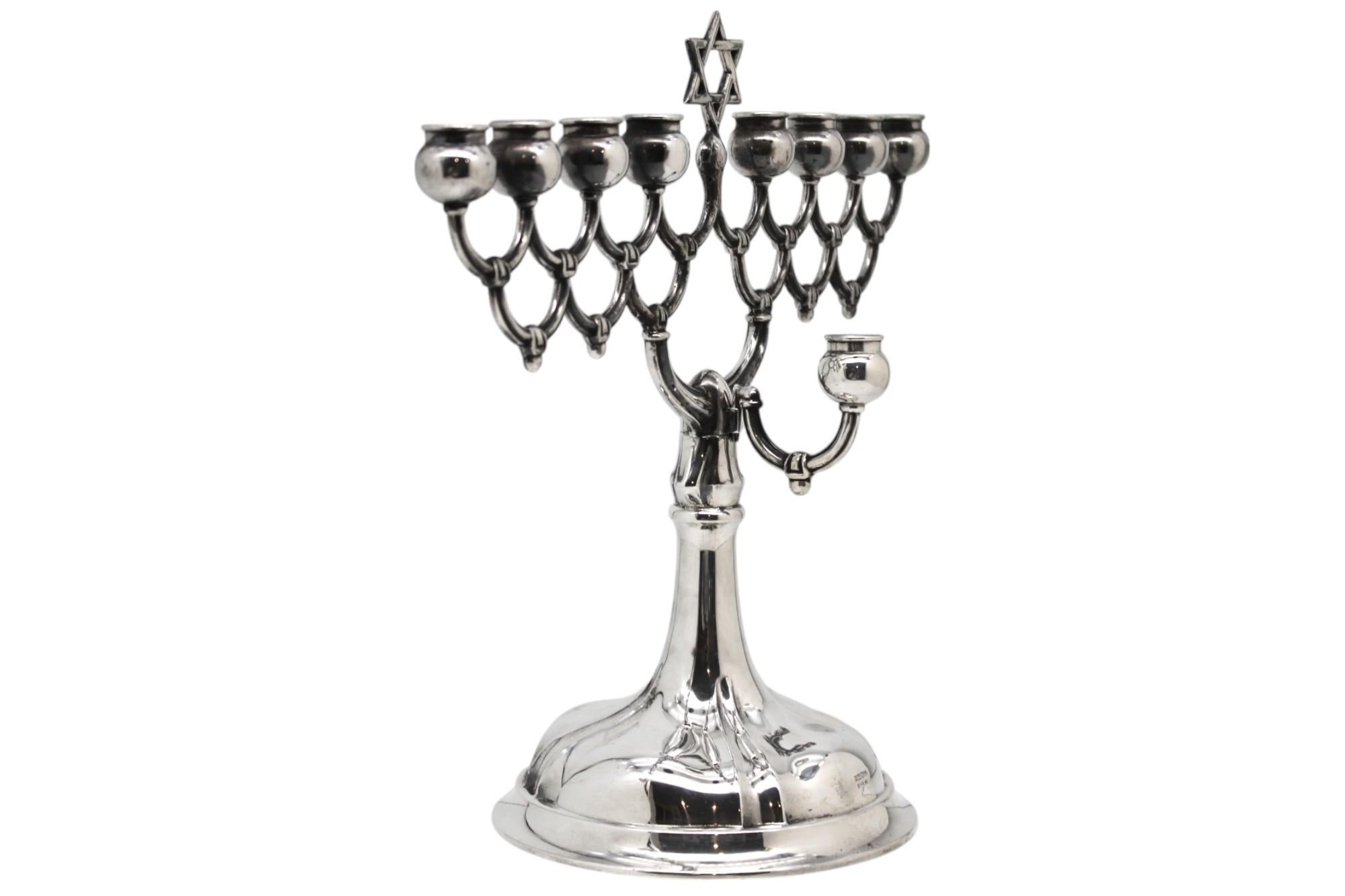 An elegant and refined silver Hanukkah lamp, crafted in Germany circa 1930. The lamp embodies the clean, balanced aesthetics of early 20th-century European silversmithing while firmly maintaining its ritual identity.

This Hanukkah lamp is raised on