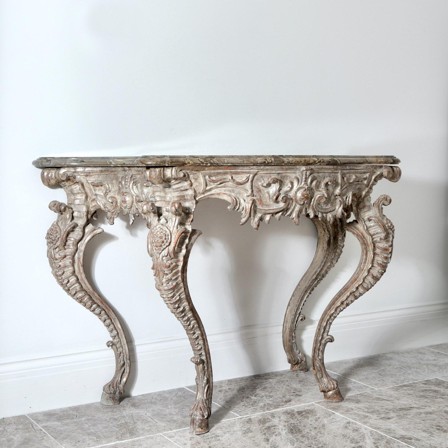 We presents an 18th century Italian console table.

Italy, Probably Naples, Circa 1790.

” A striking Italian console table with bold cabriole legs, in its original softly distressed, delicate silver leaf finish, exceptional double bevelled,