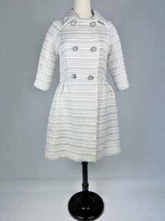 A silver lamé satin coat with jewelled buttons - France Circa 1960