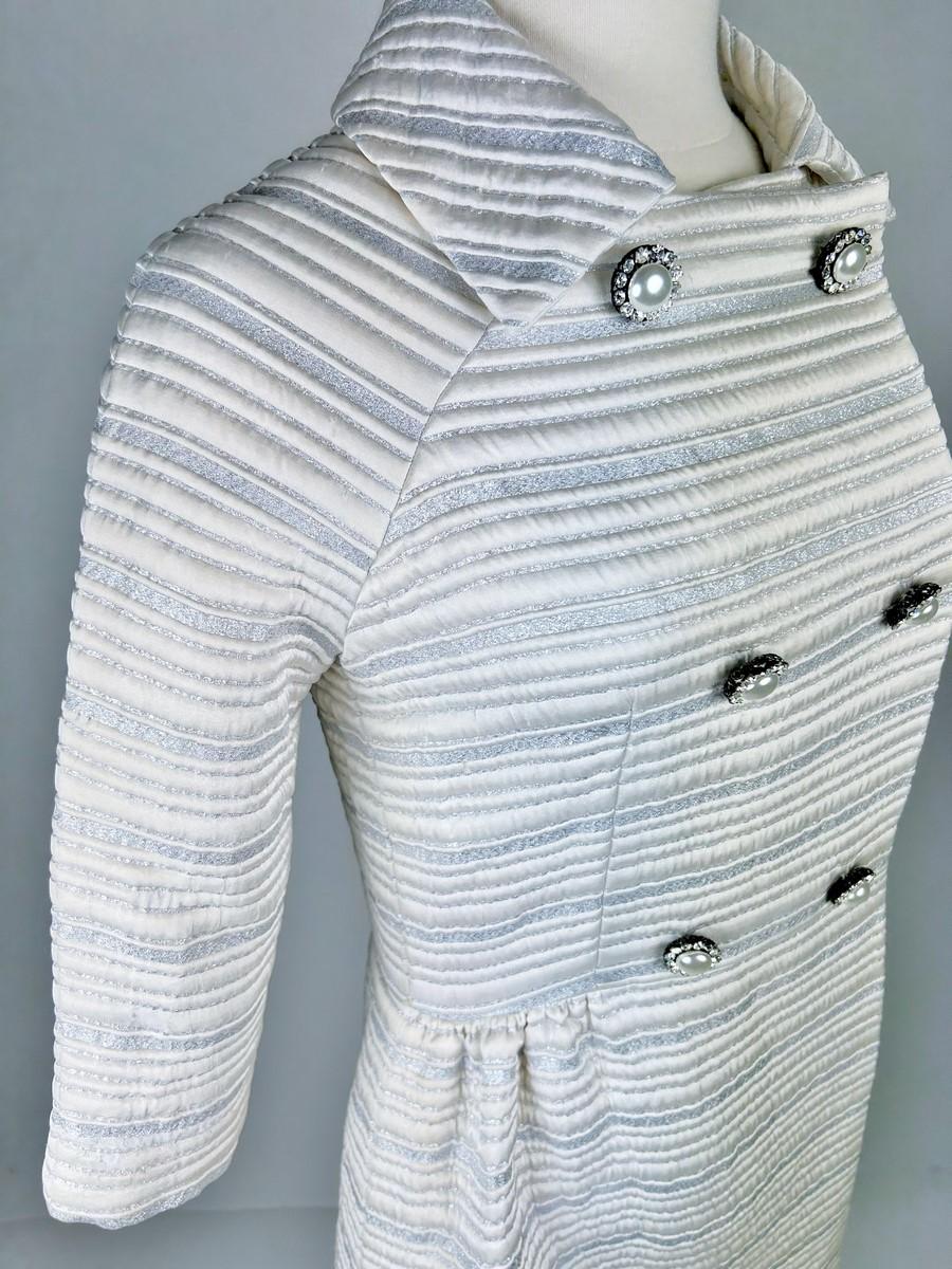 Women's or Men's A silver lamé satin coat with jewelled buttons - France Circa 1960 For Sale