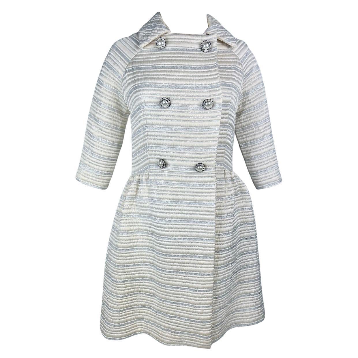 A silver lamé satin coat with jewelled buttons - France Circa 1960 For Sale