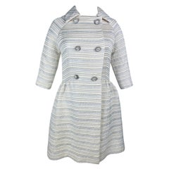 A silver lamé satin coat with jewelled buttons - France Circa 1960