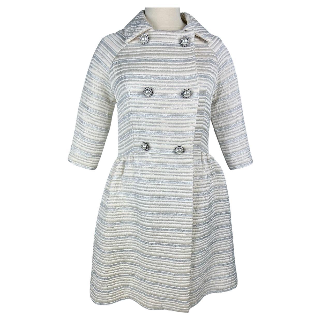 A silver lamé satin coat with jewelled buttons - France Circa 1960 For Sale