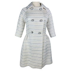 A silver lamé satin coat with jewelled buttons - France Circa 1960