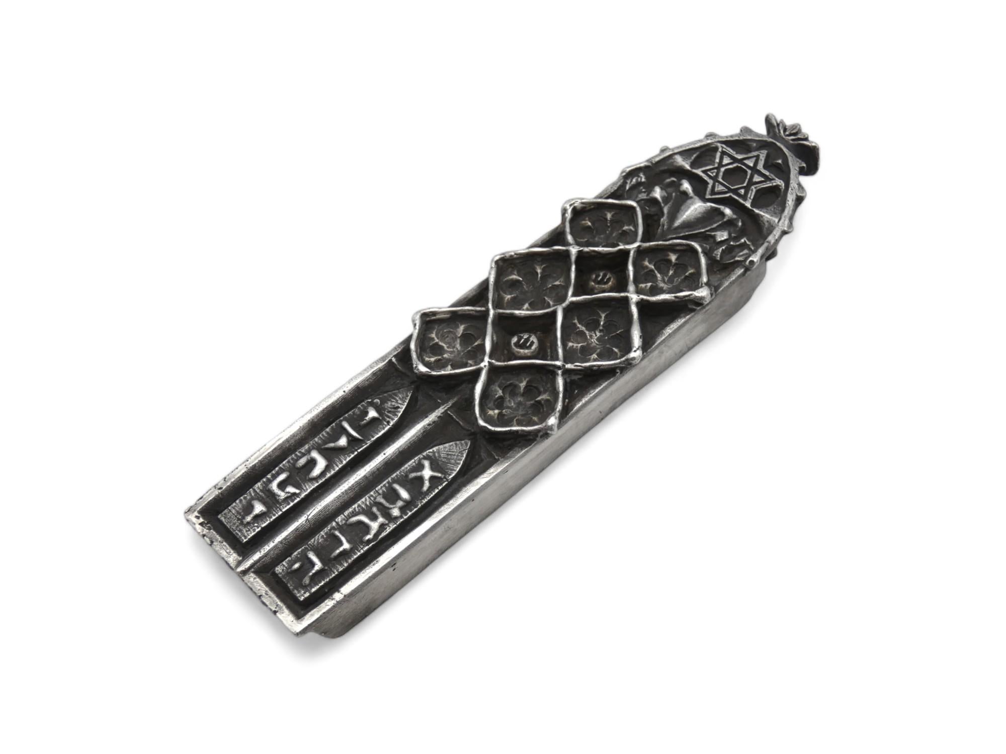 A Silver Mezuzah Case made by Mikhail Khandros in 1992.

Mikhail Khandros (1956-)Mikhail Khandros, born in Odessa, USSR, received a B.A. in Theater Design at the Odessa Theater College. In 1989 he came to the U.S., where he studied typography,