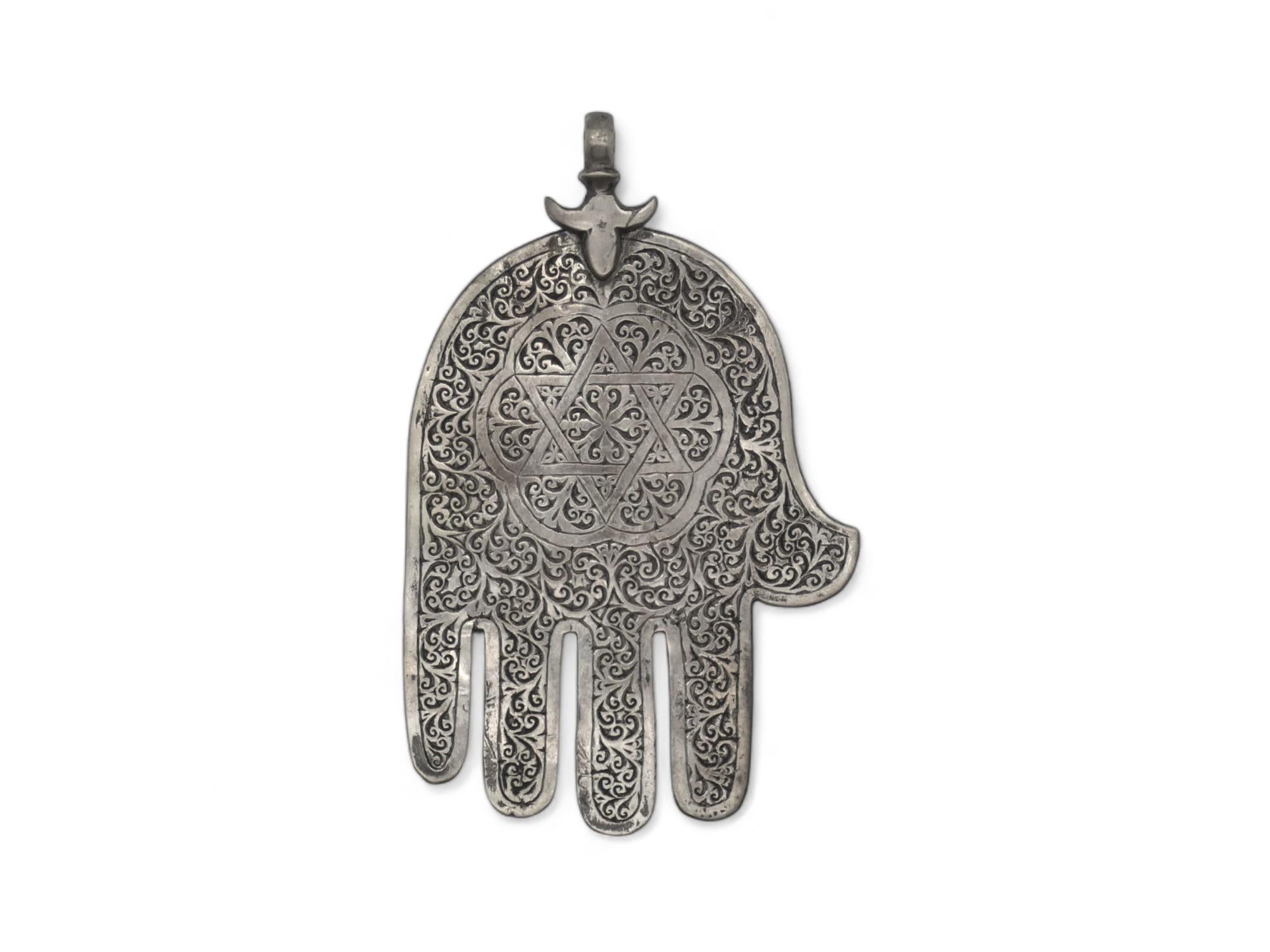 A Silver Hamsa from Morocco Circa 1900 is a classic artifact that blends Jewish symbolism with North African craftsmanship. 

During the early 1900s, Morocco was home to a diverse Jewish community known for its rich artistic traditions. Silverwork,