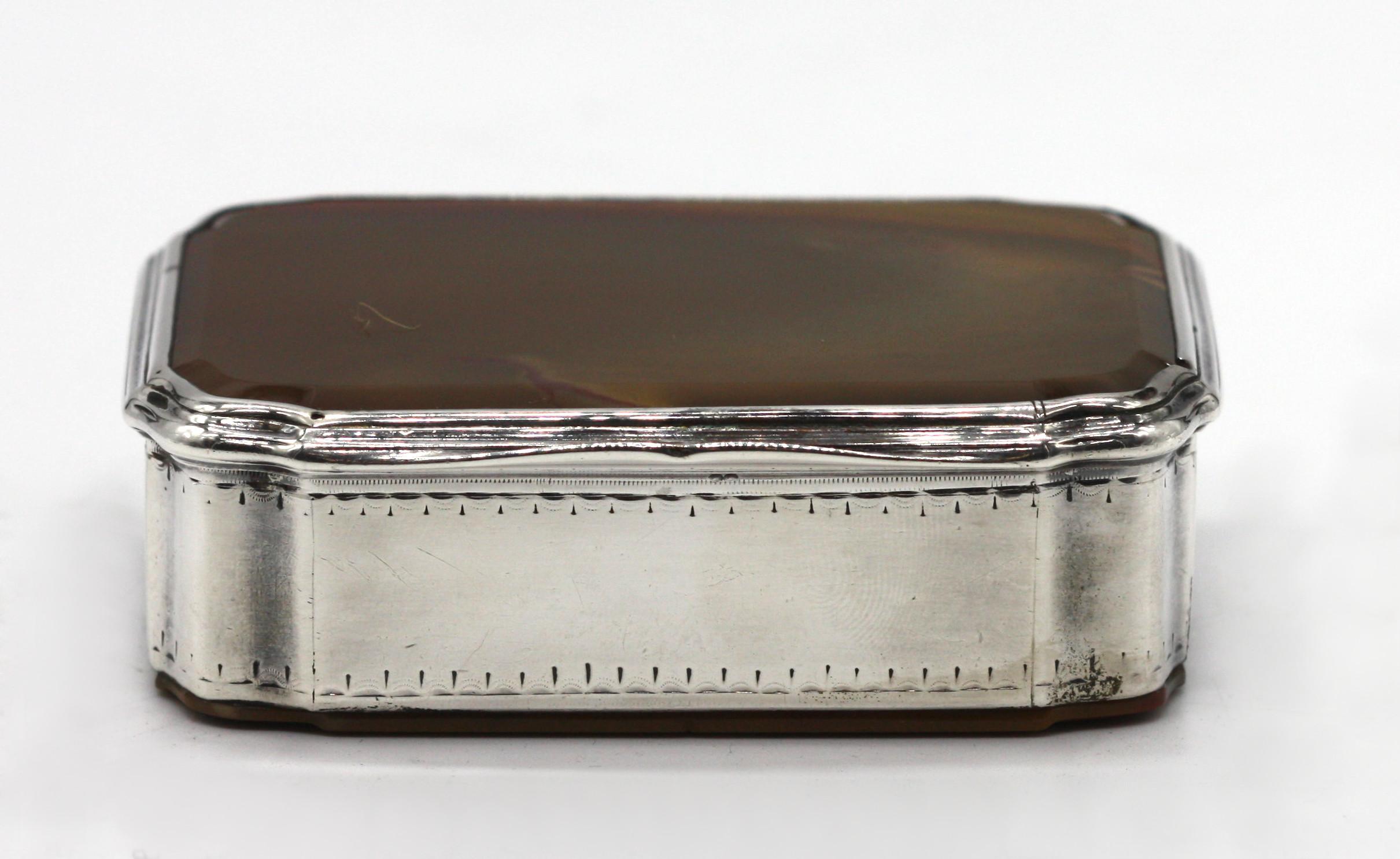 A silver-mounted agate box, probably English, circa 1870
rectangular, comprising two plaques of moss agate set as the base and lid of a hinged box with silver mounts, apparently unmarked.
Measure: Width 3.5 in. (8.8 cm.).
 