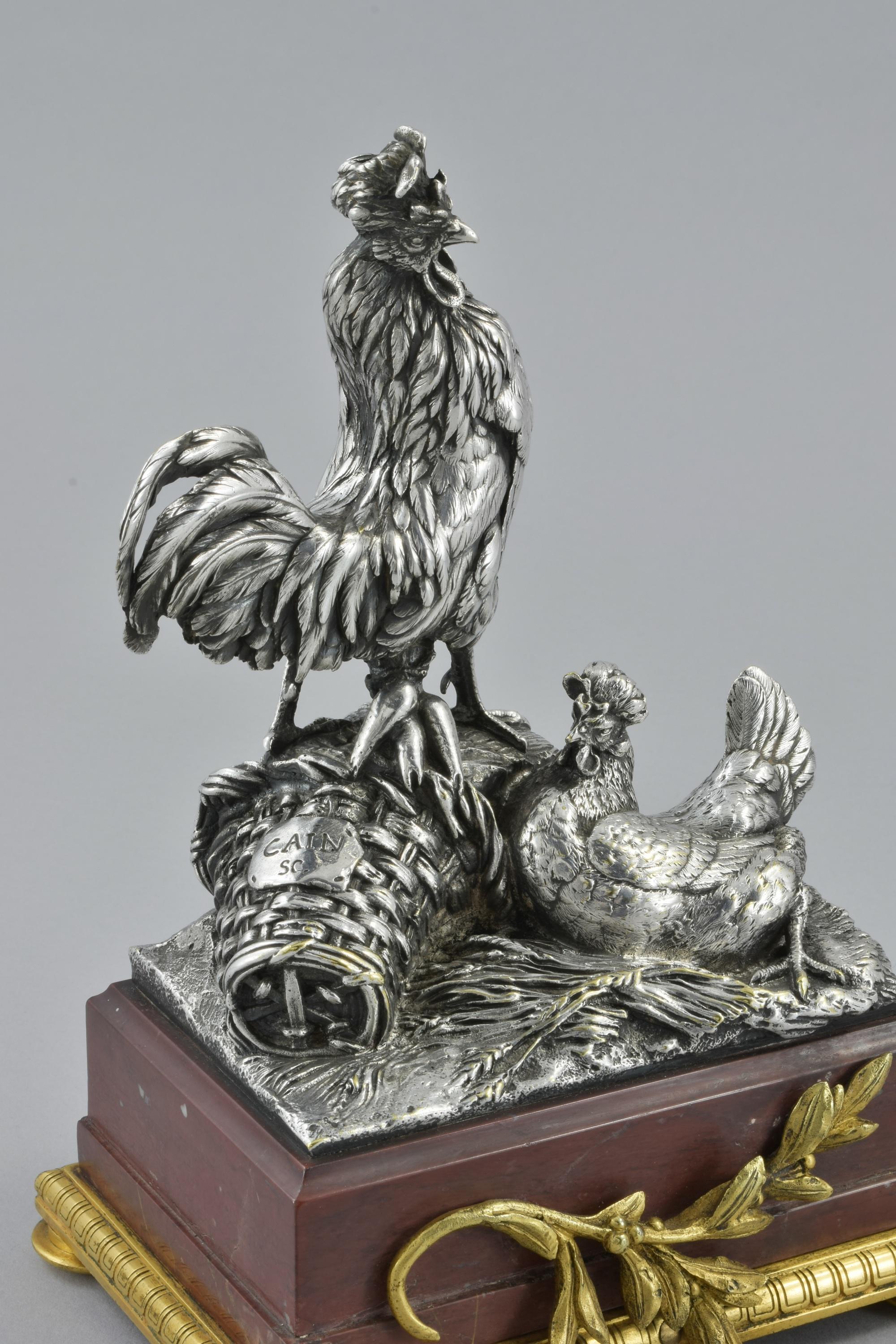 This silver plated bronze sculptural group of a Cockerel and a chicken an a gilt-bronze mounted hard-stone base was made in Circa 1890 by Christofle