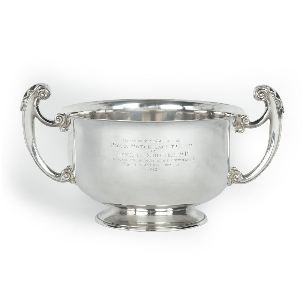 The ‘Entente Cordial’ silver champagne cooler for the British Motor Boat Club, 1905. This deep cylindrical bowl by Charles Townley and John Thomas is of heavy gauge with a raised circular foot, two acanthus scroll handles and cut-card acanthus
