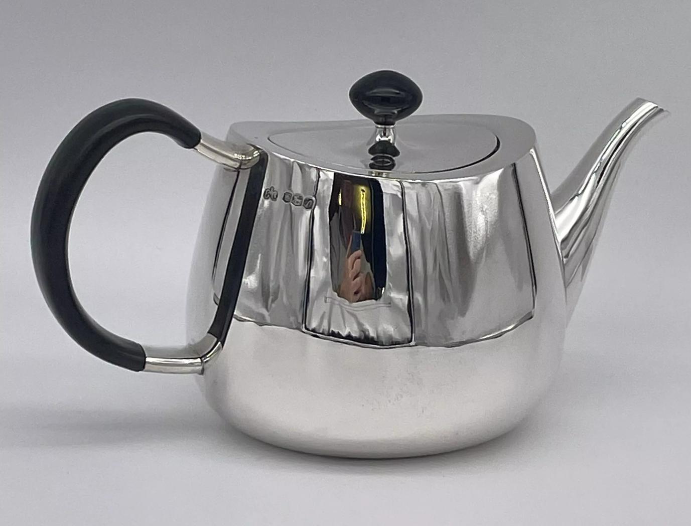 An Elizabeth II modernist sterling silver four-piece tea and coffee service, Sheffield 1962/68/69 mark of Elkington, designed by David Mellor.

Pride pattern, of plain ogee form, comprising a teapot, coffee pot, milk jug and twin handled sugar bowl.