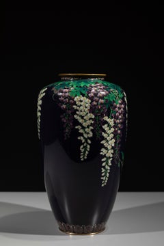 A silver wire cloisonné vase with wisteria on a midnight blue ground, signed Ota