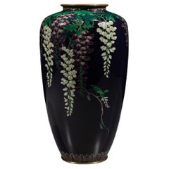 A silver wire cloisonné vase with wisteria on a midnight blue ground, signed Ota