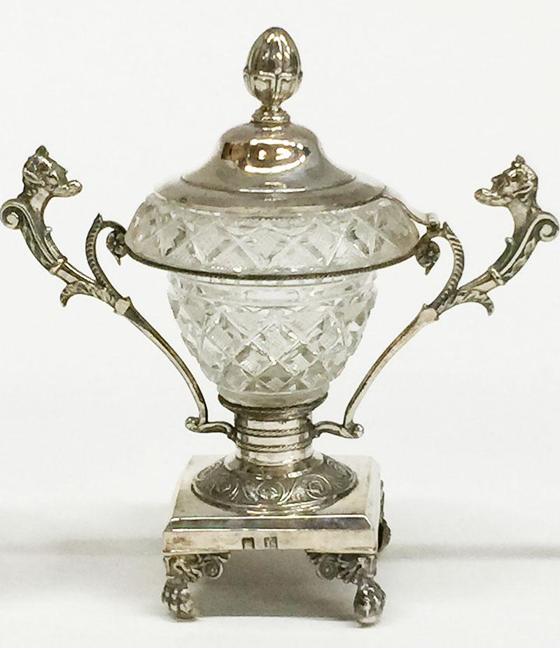 A silver with crystal serving set with 2 small candy dishes and 2 salt cellars

The set is marked with Dutch silver Hall Marks
The Dutch Maker's mark is Snoek Polle-Joh. , Haarlem 1852-1858
The Axe-Mark used 1853-1927 as a Tax Mark on old Dutch Hall