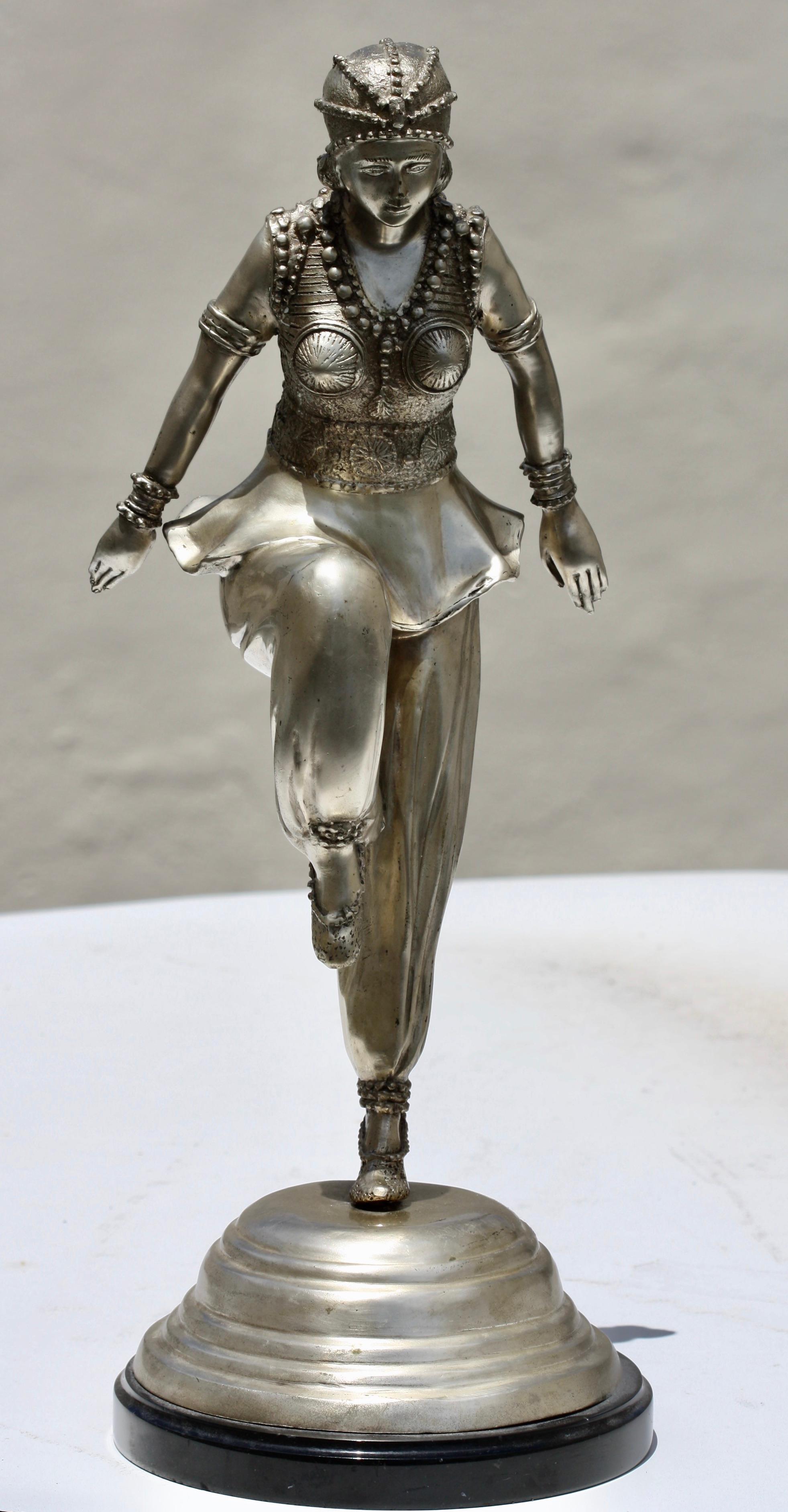 After Claire Colinet (1880-1950)
A silvered bronze dancer after a model by Claire Colinet (1880-1950)
modelled with her arms outstretched behind her, on a black marble plinth
20th Century
21 inches high
8 inch round base.