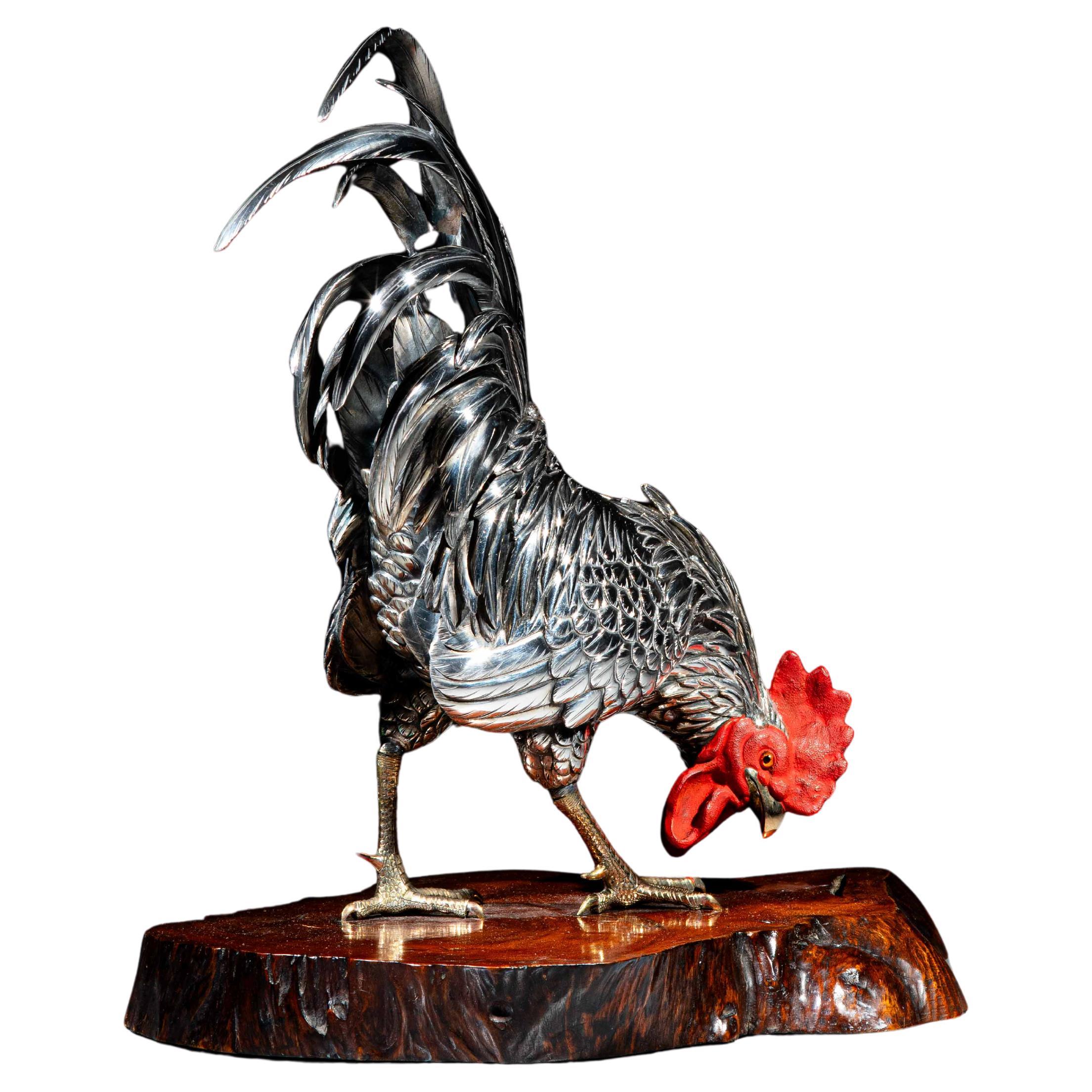 A silvered bronze okimono depicting a rooster signed Yoshiaki