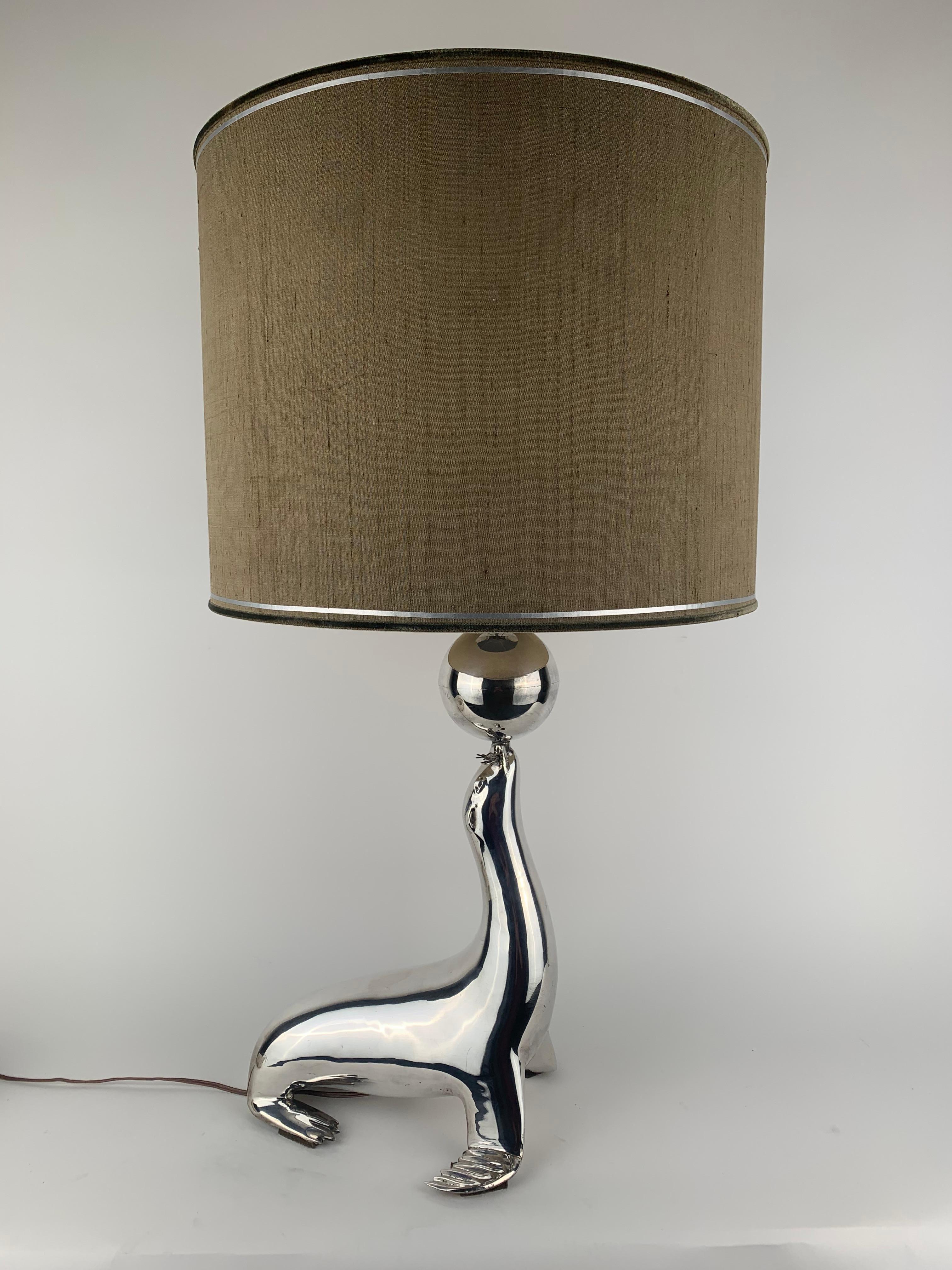 A silvered seal with a ball on his nose as a table lamp. 
Turn on 1 or 2 lamps. Original shade, 