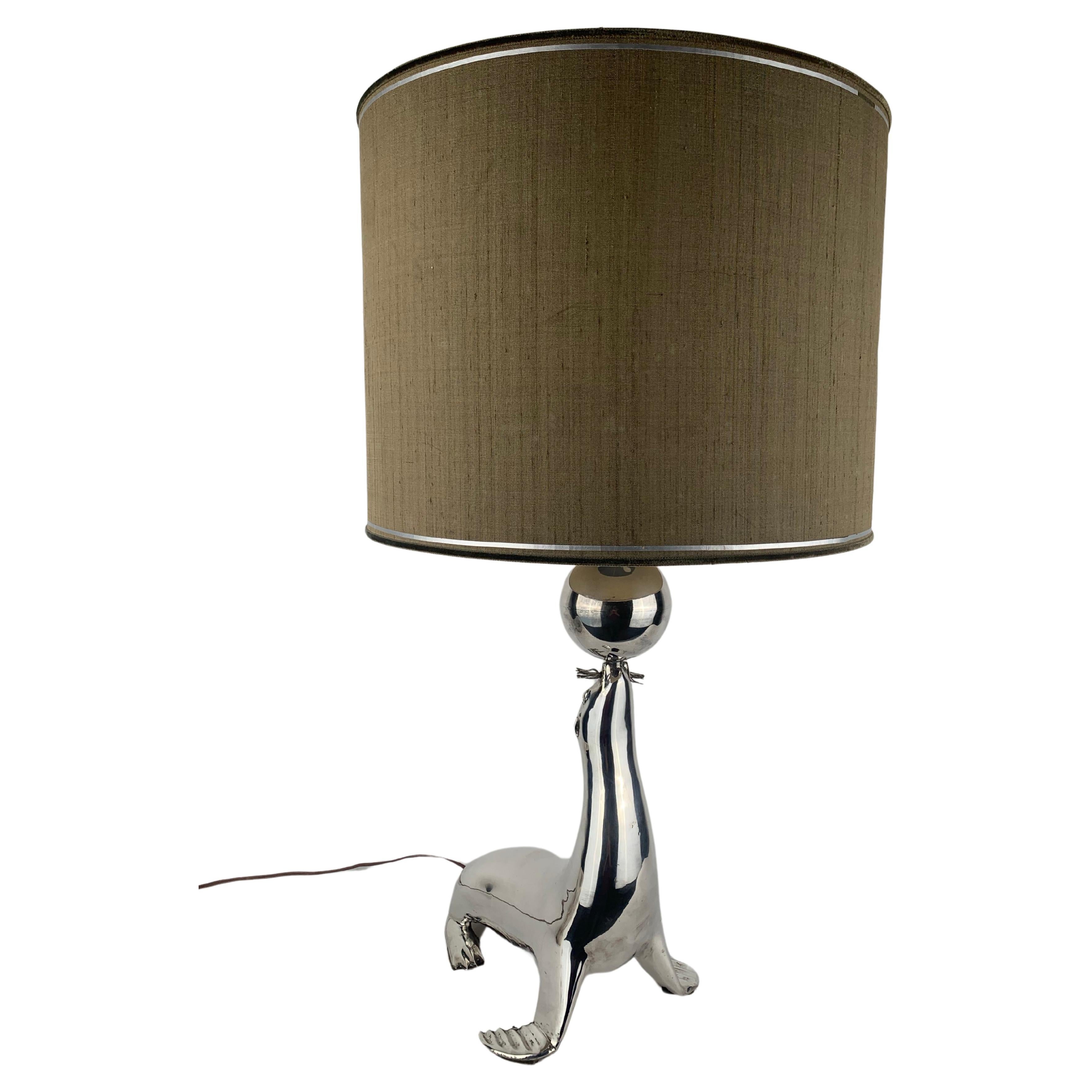A silvered seal as a table lamp For Sale