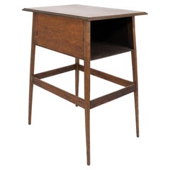 A simple oak oblong side or bedside table with a moulded edge to the top