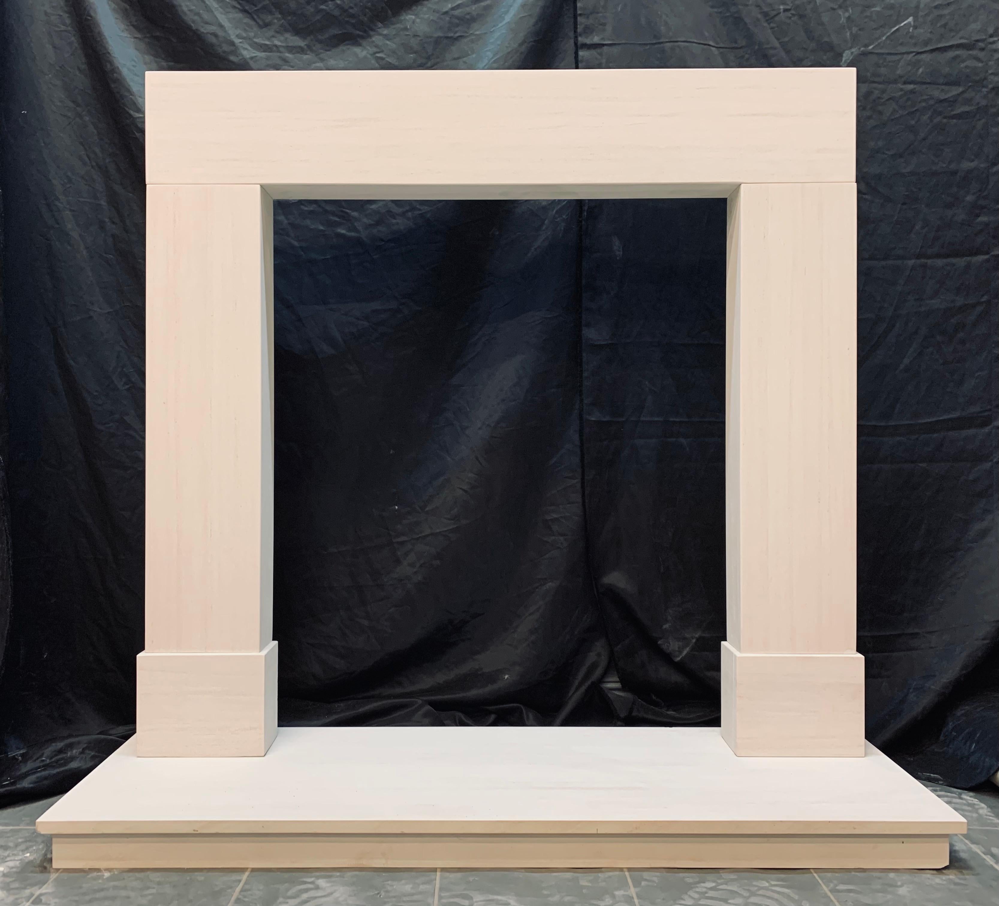 A simple period limestone fireplace surround. Consisting of a lintel and two supporting jambs, all resting on plain foot blocks. 
This type of fireplace has been in use since fireplaces were first installed, they are sometimes called post & beam