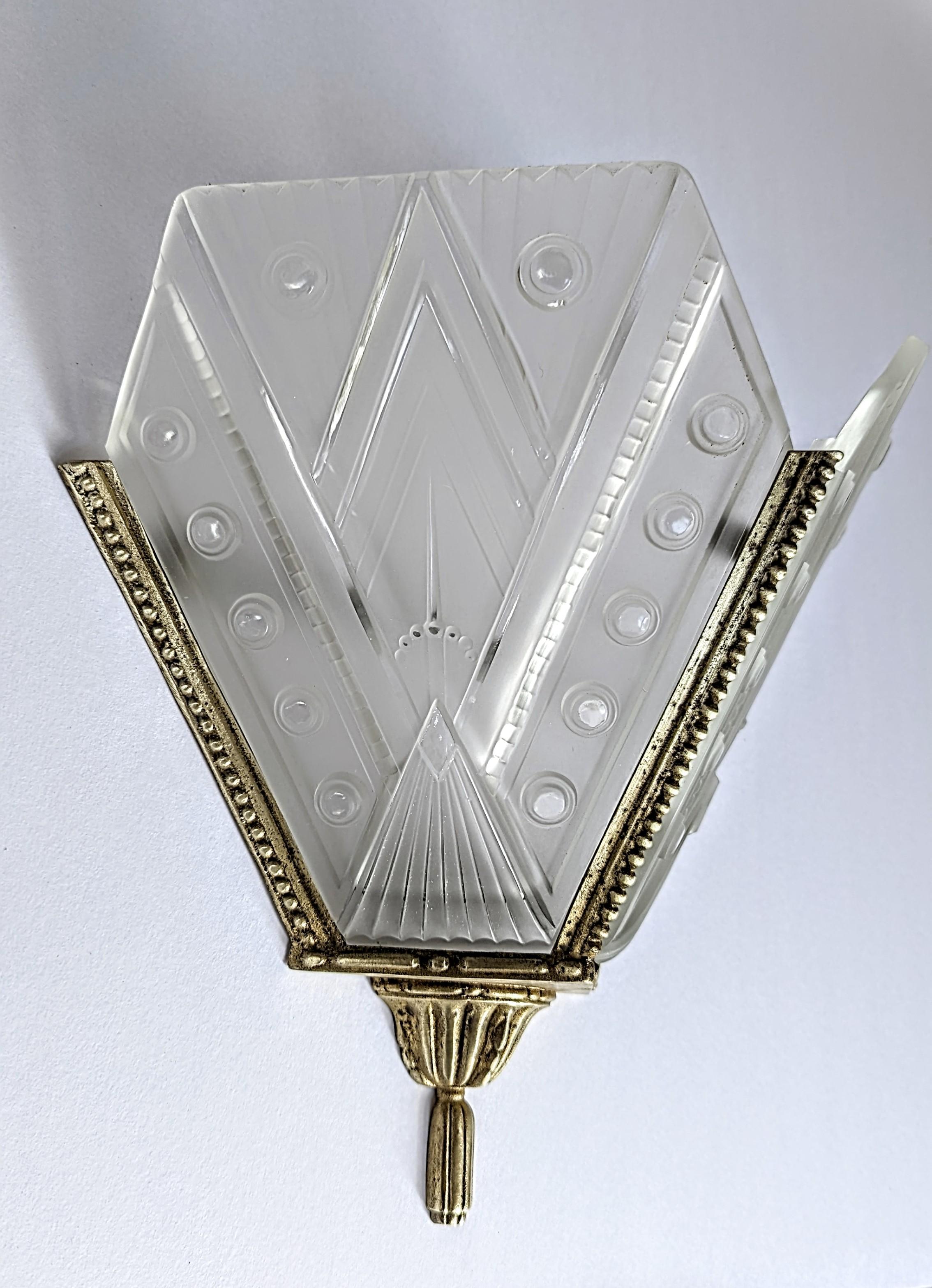 A pair of French Art Deco wall sconces were designed by the master 