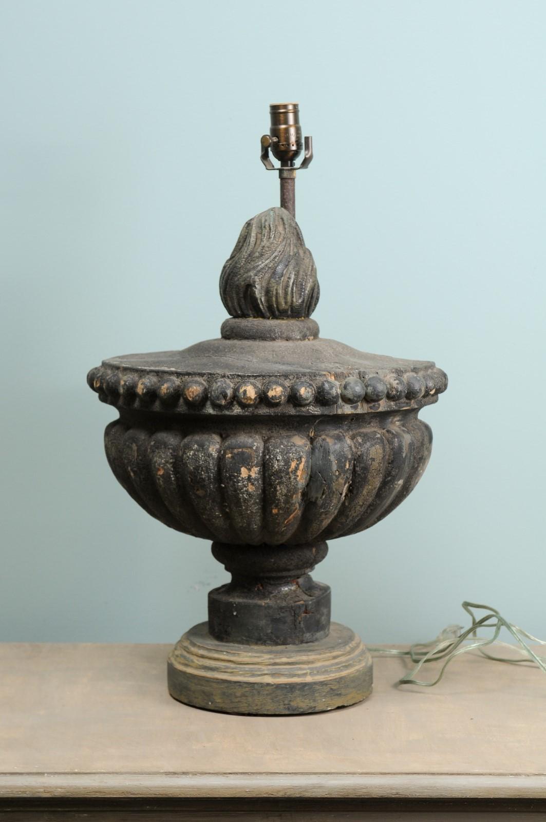 A custom single table lamp of an Italian early 19th century carved-wood fragment. This Italian fragment lamp features a carved wood urn with flame at top, which has been raised on a rounded base and lamp post mounted along it's backside. The