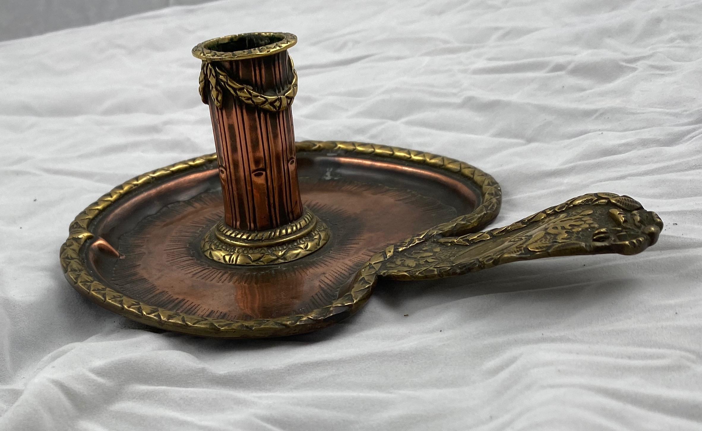 A small and sweet candlestick made of copper and brass.