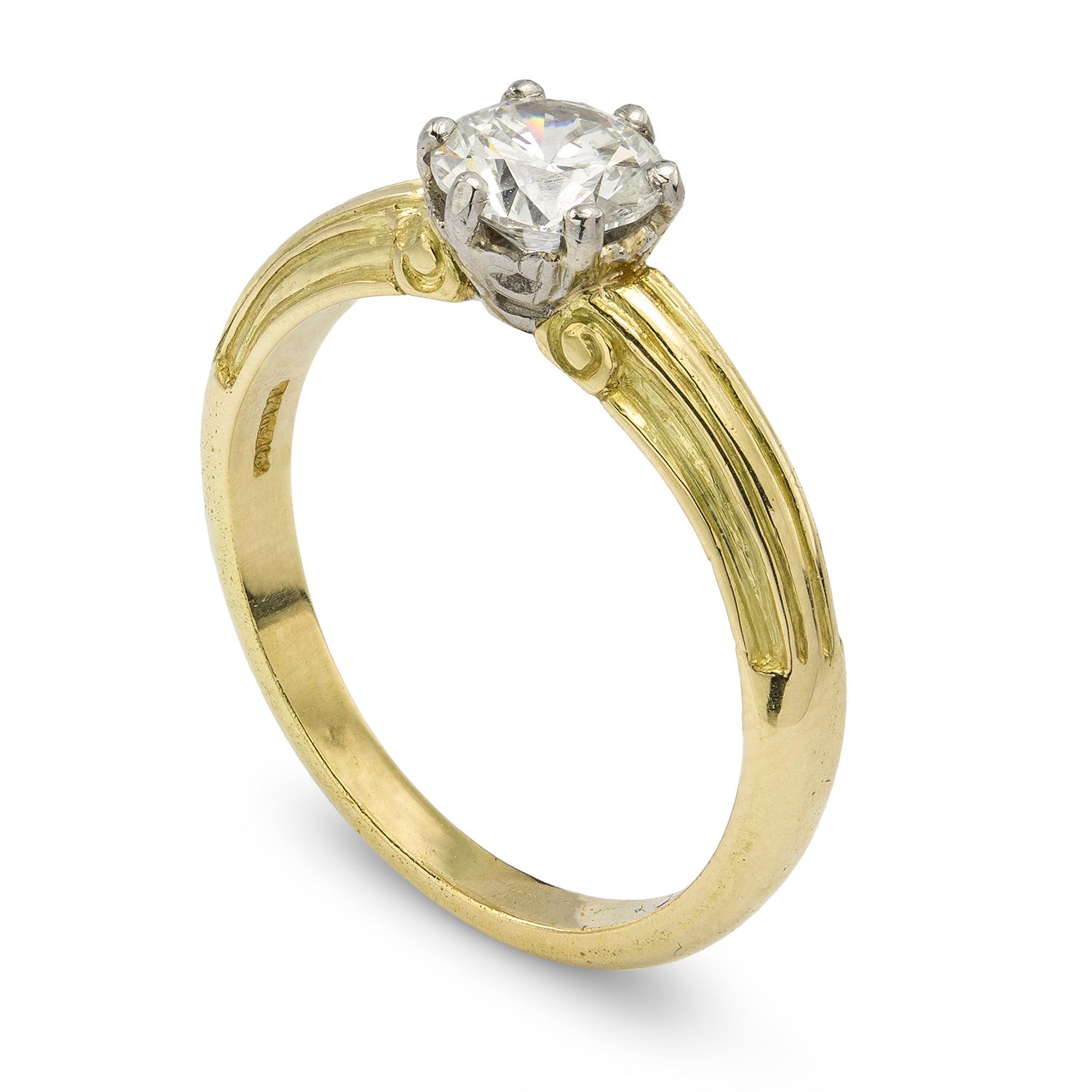 A single stone diamond ring, the round brilliant-cut diamond accompanied by GCS report stating the diamond to weigh 0.70 carats, to be of H colour and VS2 clarity, claw set in platinum collet to an 18ct yellow gold mount with carved ribbed