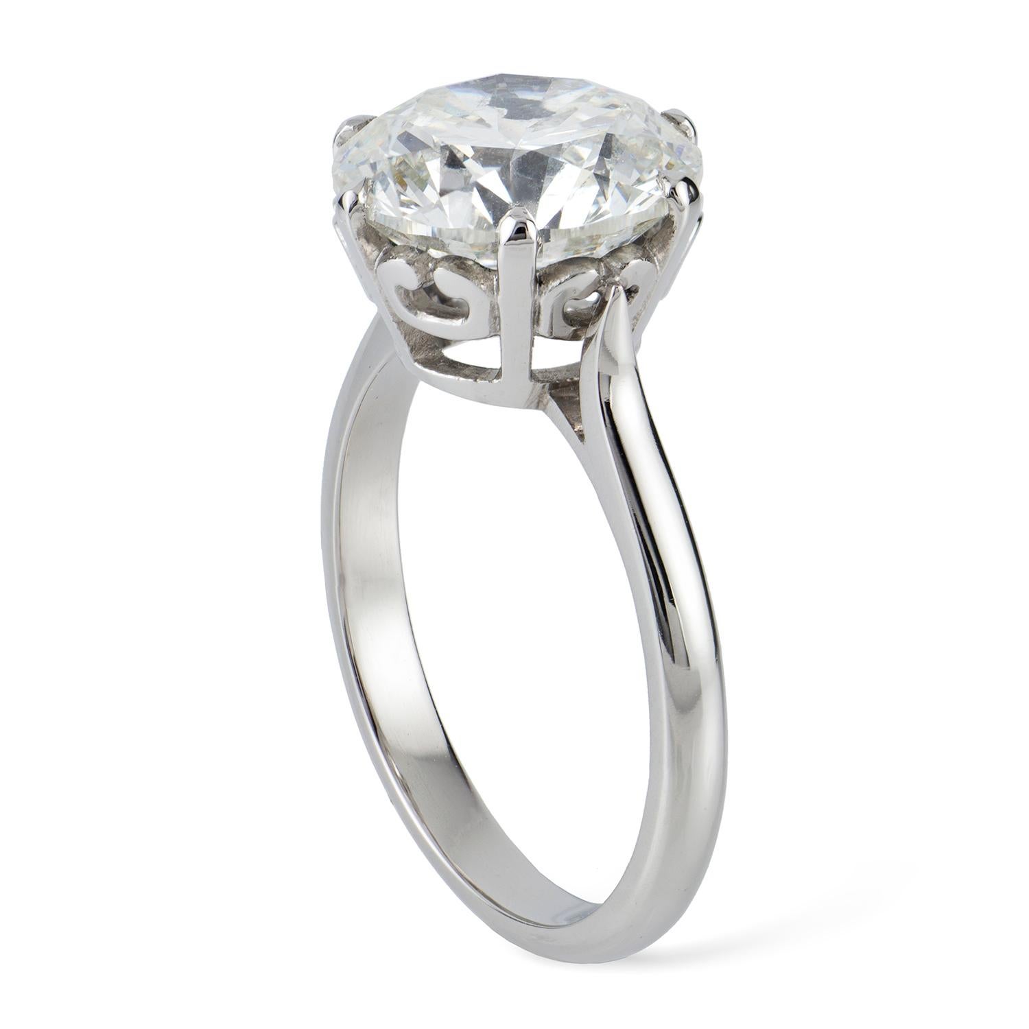 A single stone diamond ring, the round brilliant-cut weighing 5.01 carats, accompanied by GIA Report stating to be of I colour and I1 clarity, eight-claw set to an openwork collet with scroll decorations, to tapering D-section shank, all made in