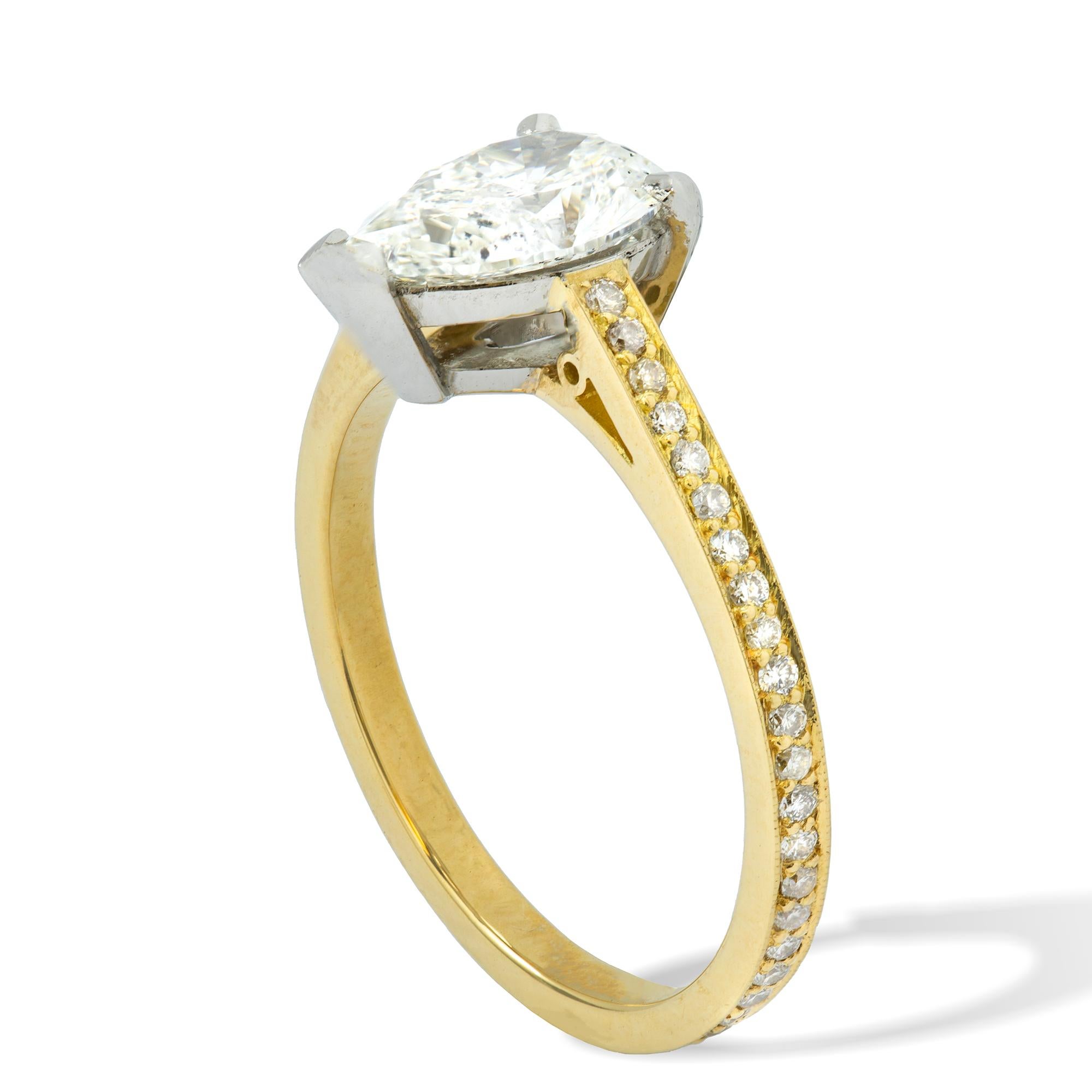 A single stone diamond ring, the pear-shaped diamond weighing 1.13 carats, accompanied by GCS certificate stating to be of I colour, VS1 clarity, claw set in a platinum collet, to a yellow gold diamond encrusted millegrain-set shank, hallmarked 18ct