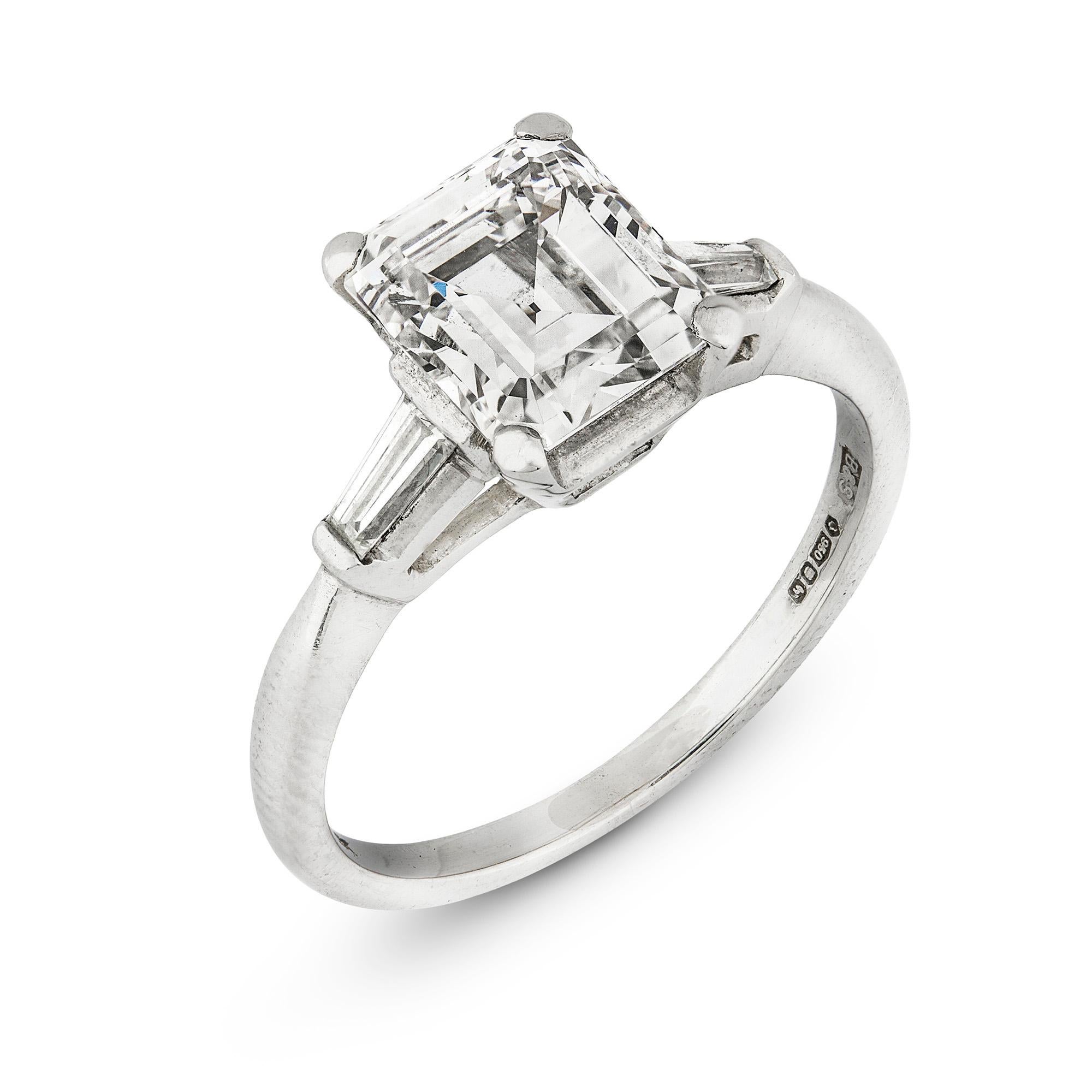 A single stone diamond ring, the emerald-cut diamond weighing 2.15 carats of G colour VS1 clarity, with GIA certificate, with tapered baguette-cut diamond-set shoulders, all set in platinum with tapered D-section shank, hallmarked London 2007,