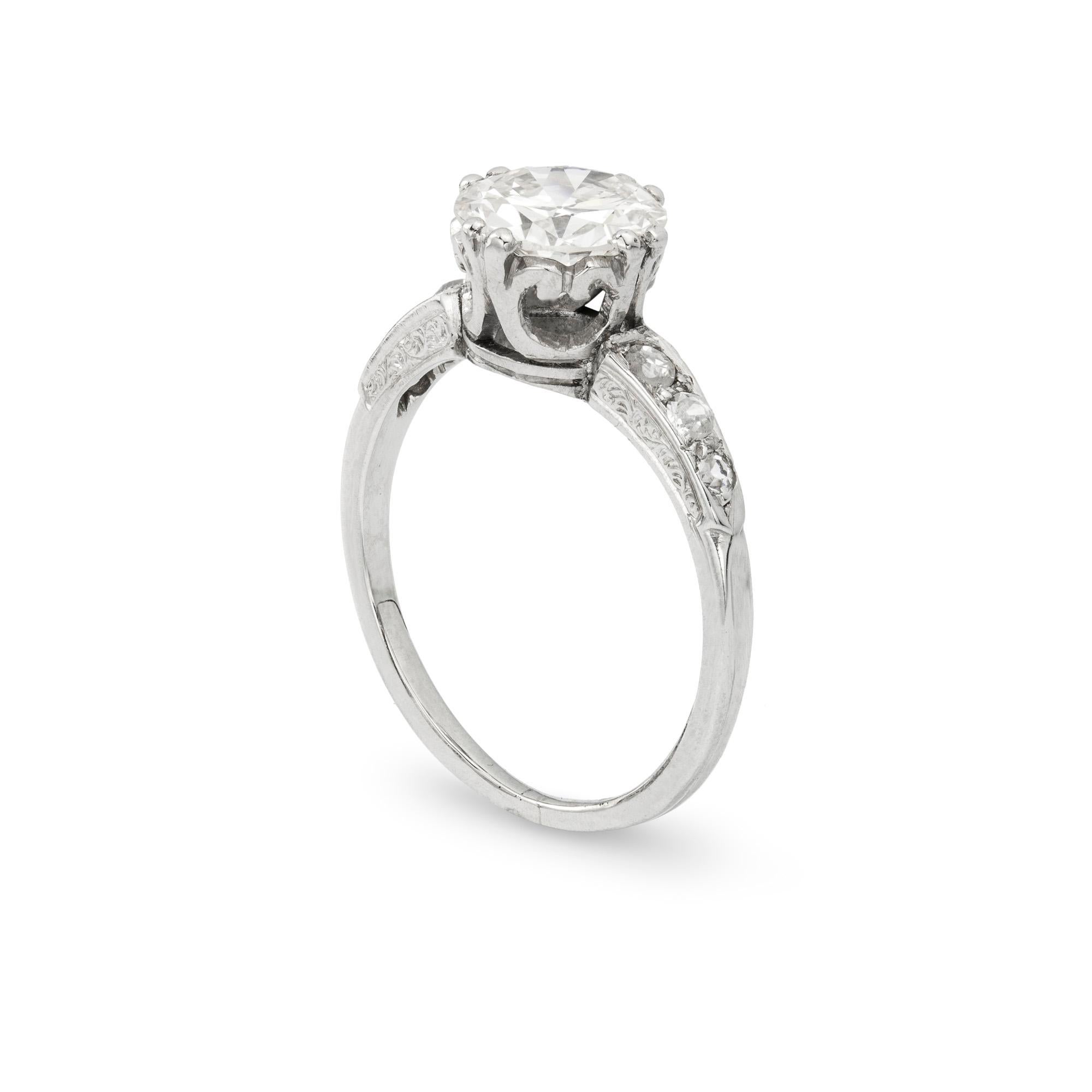 A single stone diamond ring, the brilliant-cut diamond weighing 1.03 carats of K colour and I1 clarity, shoulders set with graduating diamond-set shoulders, to a carved mount and ribbed shank, all in platinum, circa 1930, later hallmarked 950
