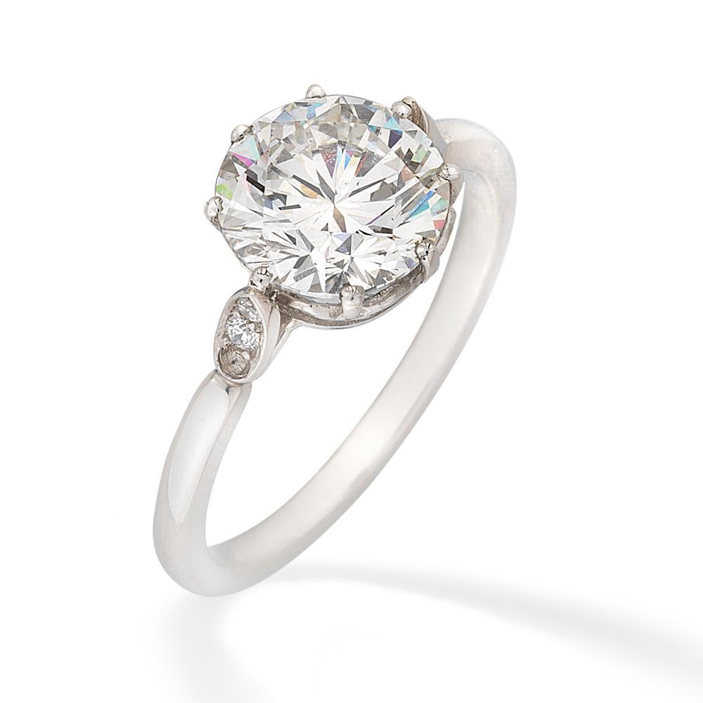 A single stone diamond ring, the round brilliant-cut diamond weighing 2.15 carats  accompanied by AnchorCert report stating to be of F colour and VVS2 clarity, 6 claw-set to an open collet between diamond set shoulders, to a D section shank, later