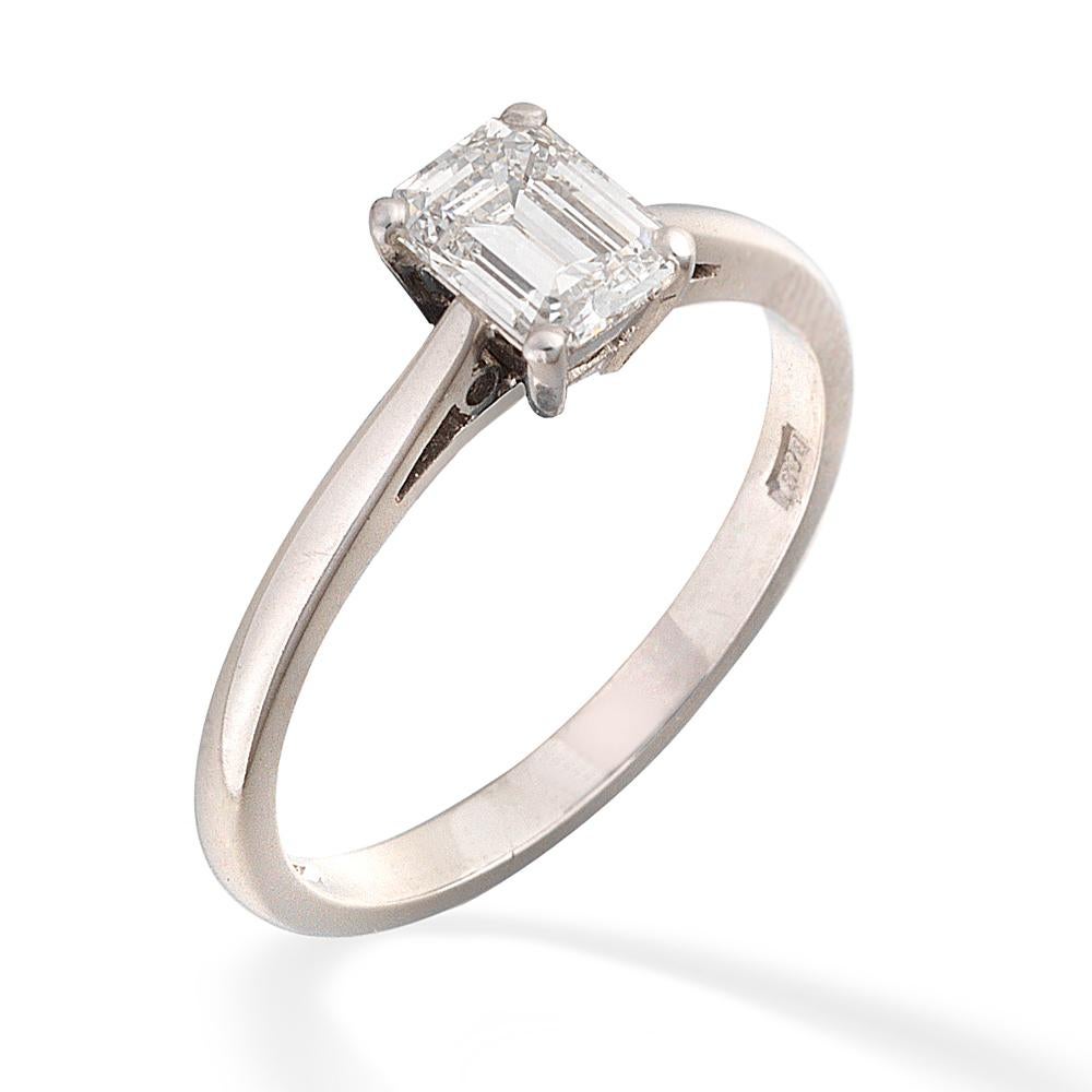 A single stone diamond ring, the E colour, VVS1 clarity emerald-cut diamond weighing 0.76 carats, accompanied by GIA certificate, white four claw-set to pierced shoulders, hallmarked platinum for London 2002, bearing the Bentley & Skinner sponsor