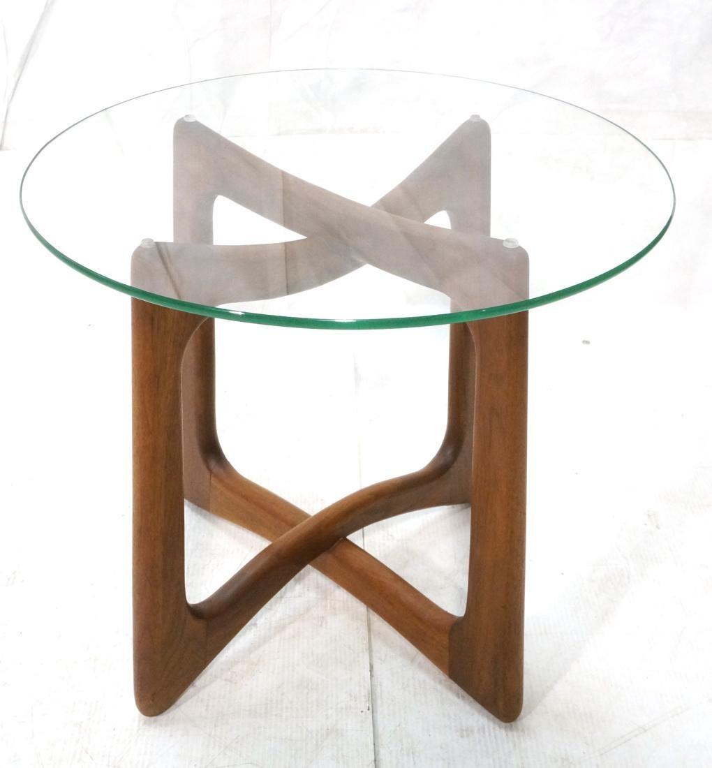 A single walnut end tables with round glass top by Adrian Pearsall for Craft Associates, USA, circa 1950.

Unsigned.

Dimensions: 20.5 inches H x 24 inches W.