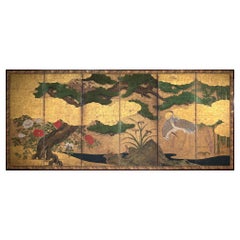 A six-panel Kano-school gold-leaf screen depicting cranes beneath a majestic pine tree