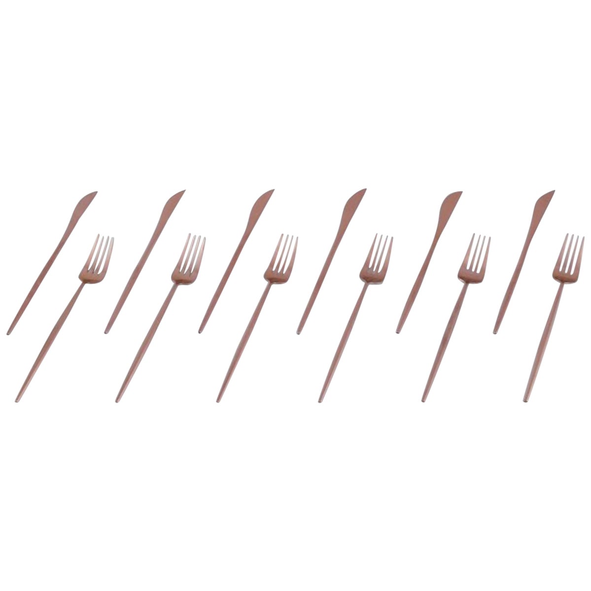 A six-person modernist dinner cutlery set in brass.