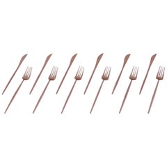 A six-person modernist dinner cutlery set in brass.